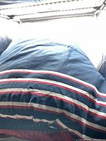 Comforter laid out showing striped navy, red, white design