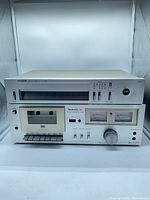 Front view of Technics cassette deck stacked beneath Citizen tuner
