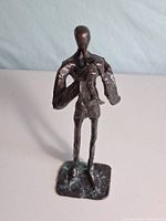 Front view of brass saxophone player sculpture