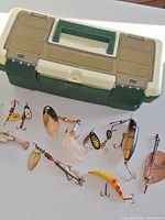 Tackle box closed with lures spread out