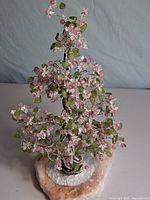 Full view of wire tree sculpture on quartz base