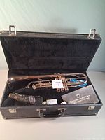 Trumpet in case with mouthpiece, oil, grease, cloth visible