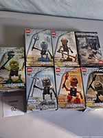 Seven boxed LEGO Bionicle sets displayed on tabletop