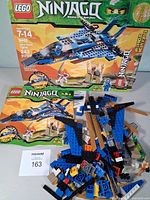 Front of LEGO Ninjago 9442 box, manual and loose pieces visible