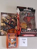 Lot overview showing sealed action figure, comic and card deck