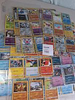 Overview of assorted Pokémon TCG cards spread in sleeves