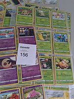 overview of green and purple Pokémon cards with lot tag