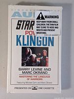 Front of sealed Power Klingon cassette showing title, authors, artwork, warning label