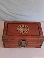 Top view showing rosewood lid and brass longevity medallion