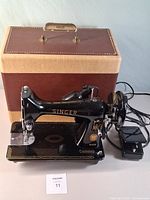 Singer Model 99-31 sewing machine on base with foot pedal and brown case