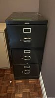 Full front view of black three-drawer filing cabinet