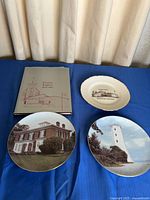 Group shot of three plates and book