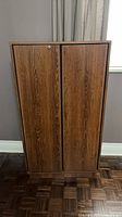Front view of closed brown wood cabinet