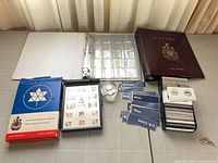 Overview of stamp box, two coin binders, labels, coin flips and holder