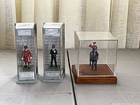 Overview of all three miniatures with packaging and cases