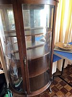 Full view of curved glass cabinet front with door closed