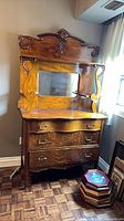Front view of tiger oak buffet showing drawers, mirror, crest, grain