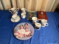 Full lot view showing all ceramics and both books