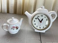 Both items side by side: teapot-shaped clock and Sadler miniature teapot