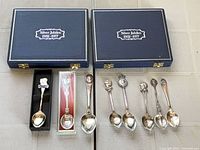 Two closed Jubilee cases, boxed spoon, display-case spoon, large spoon, four loose souvenir spoons