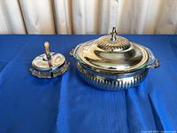 Casserole with lid beside condiment dish