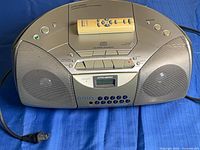 Front view of Sony CFD-S250 boombox with remote on top and power cord visible