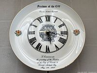 Front view of porcelain wall clock showing entire face