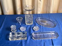 Group shot showing all eight glass pieces on blue surface