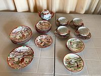 Full lot layout showing plates, bowls, cups, saucers and teapot