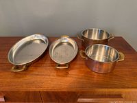 Group shot of all four cookware pieces on wooden surface