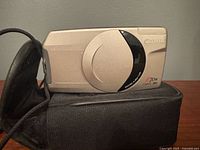 Front view of Canon Prima Super 28N camera resting on case