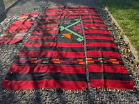 All three rug pieces laid out on pavement showing relative sizes and patterns