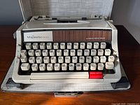 Front view of Majestic 800 typewriter showing keyboard, woodgrain panel and branding