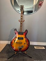 Full front view of Raven semi-hollow electric guitar on stand