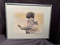 Full view of framed photograph with mat and silver frame