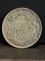Reverse of 1938 Canada 50 Cents coin showing coat of arms
