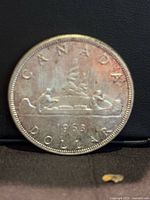 Reverse of 1963 Canada dollar showing Voyageur design and date