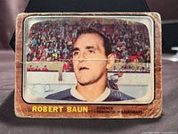 Front of Robert Baun card showing image, name, position and team with visible wear