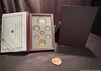 Set open showing coins, certificate, case and slipcover