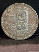 Reverse side showing totem pole and inscriptions