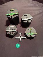 Top-down view of five die-cast WWII fighter models on stands