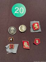 Six Soviet Lenin badges arranged on surface showing fronts