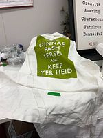 Front view of apron showing full text and fabric