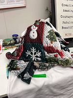 Folded fleece throw showing patchwork Christmas design on table