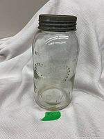 Front view of Crown mason jar showing crown logo and metal lid