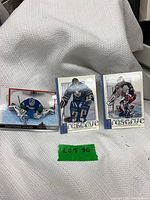 Front view of three goalie hockey cards