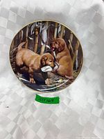 Front view of plate showing dog scene and gold rim