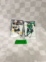 Both hockey cards laid flat showing front images and player names