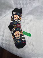 Full view of one sock showing skull and floral pattern