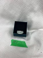 Front view of sterling silver opal ring in box showing five opals